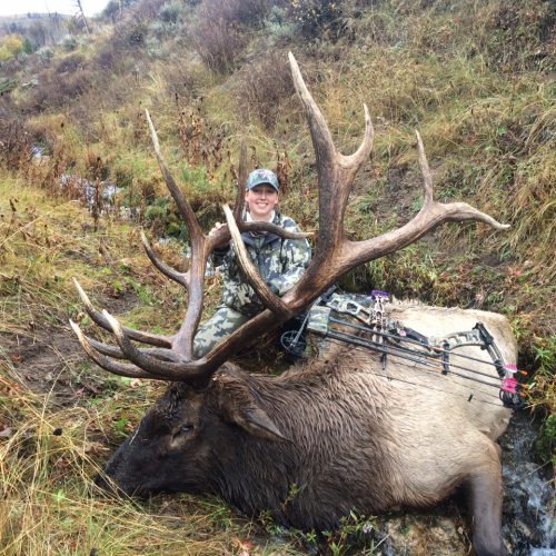 Sara (Mackie) D'Agostino with a bull elk she shot with her bow